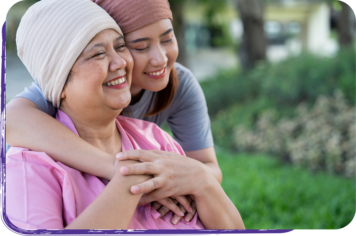 Young woman hugging an older woman outdoors